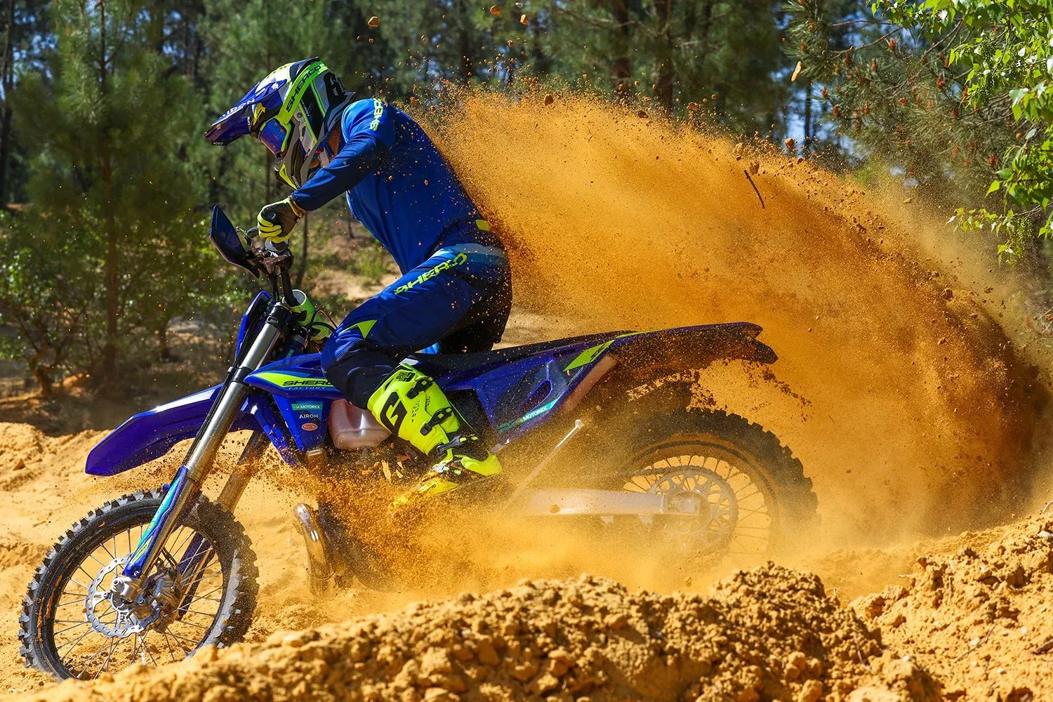 A rider on a 2027 Sherco enduro bike throwing up a wall of sand