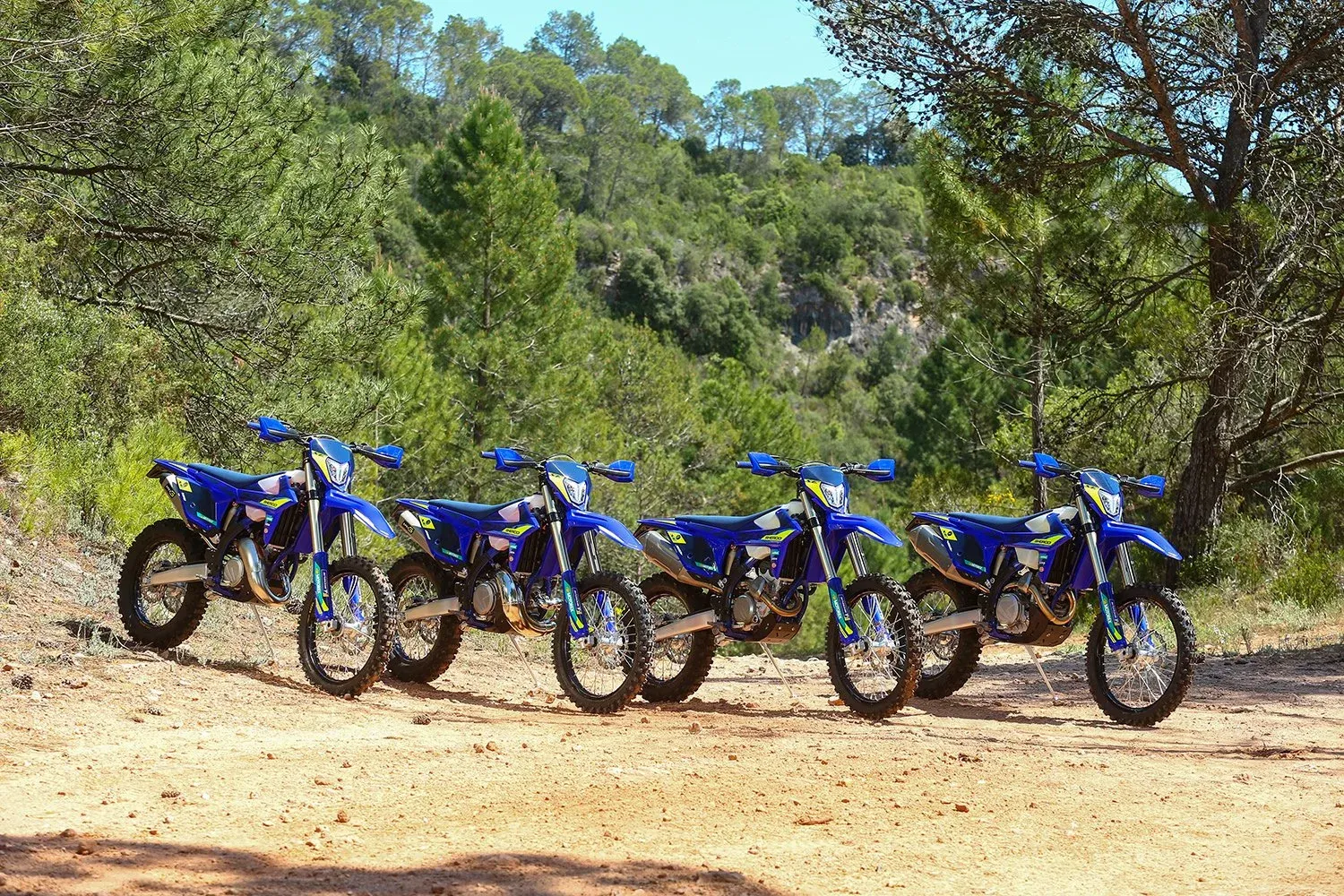 The 2027 Sherco enduro lineup parked on a forest trail
